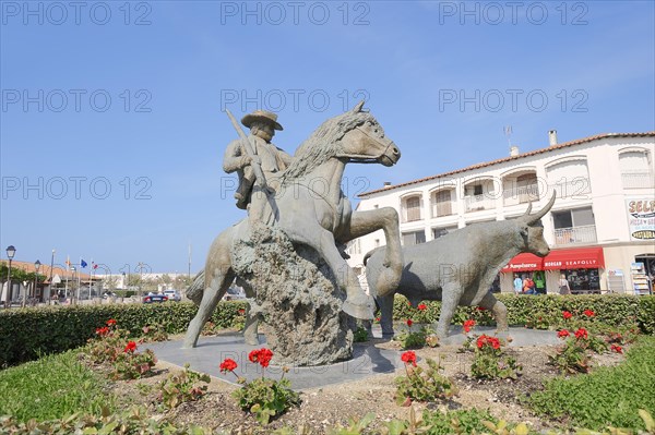 Statue of a drover with Camargue horse and Camargue bull, Les Saintes-Maries-de-la-Mer, Camargue,
