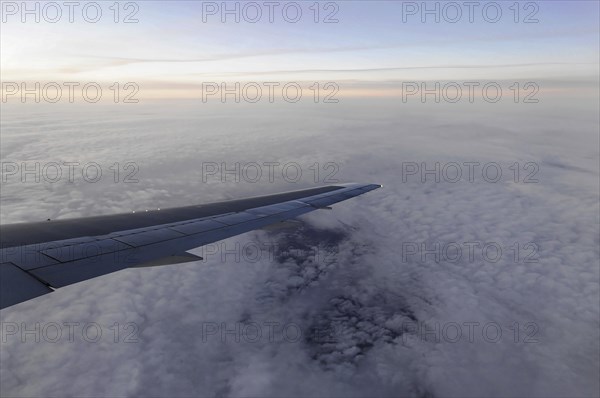 Flight to Stuttgart, Germany, Early morning view through aeroplane window of wings and cloud cover,