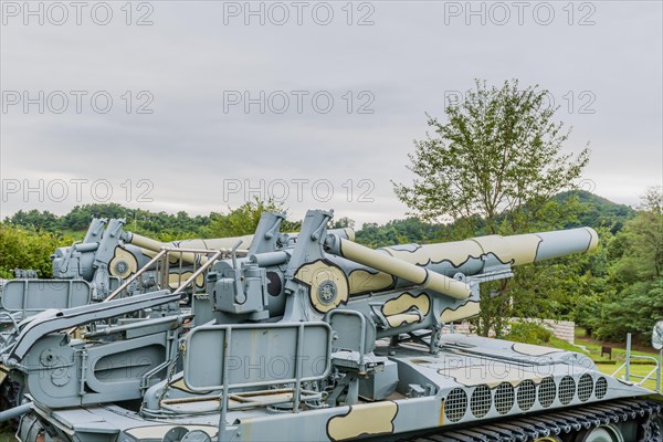 Side view of gun and controls of military tank on display in public park in Nonsan, South Korea,