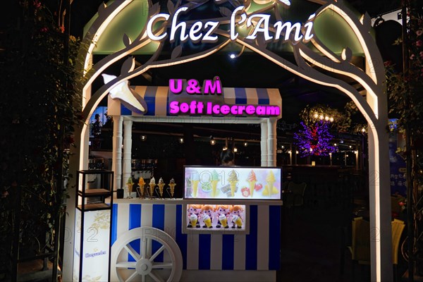 Shanghai by night, China, Asia, Illuminated ice cream van in front of a street cafe in the city at