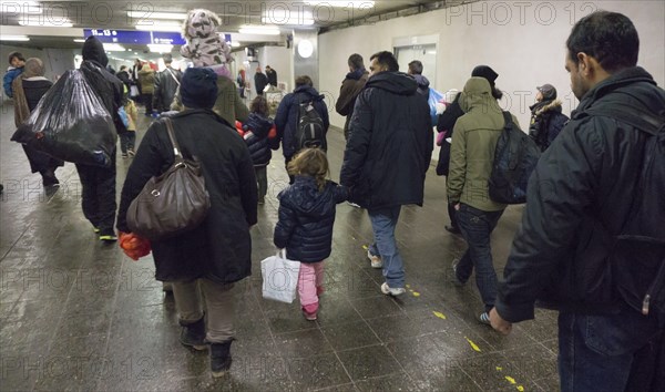 Refugees have arrived at Schoenefeld station on an IC train. They are then taken by bus to
