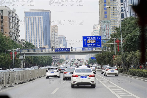 Xian, Shaanxi, China, Asia, city motorway with moving cars and road signs, surrounded by buildings,