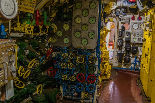 Photo of various gauges, dials, valve controls and other component inside submarine on display at