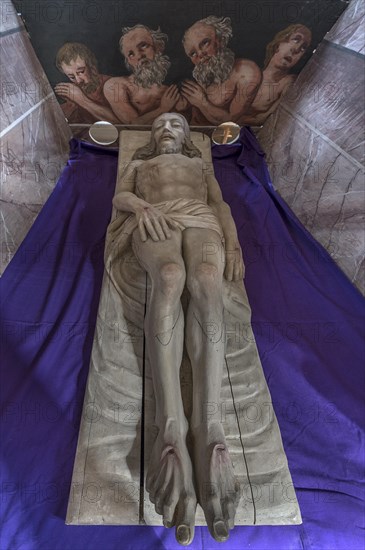 Reclining figure of Christ in the Holy Sepulchre, behind a motif of three men in purgatory, St