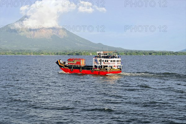 Lake Nicaragua, in the background the island of Ometepe, Colourful ferry on the lake, transporting