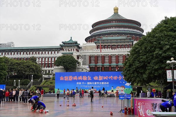 Chongqing, Chongqing Province, China, Asia, People on a square with a prominent building in the