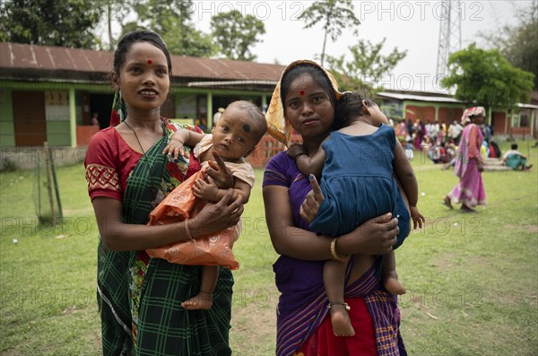 BOKAKHAT, INDIA, APRIL 19: Women with child show their marked finger after casting their votes