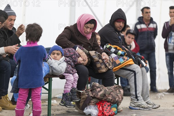 A Syrian refugee family and their children wait in a tent at the Berlin State Office for Health and