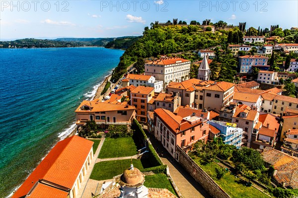 View from the bell tower over Piran with city walls and castle, harbour town of Piran on the