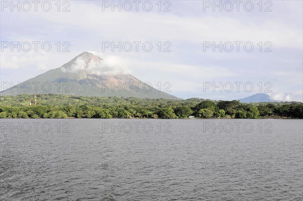 Lake Nicaragua, Ometepe Island in the background, Calm lake with a view of a smoking volcano,