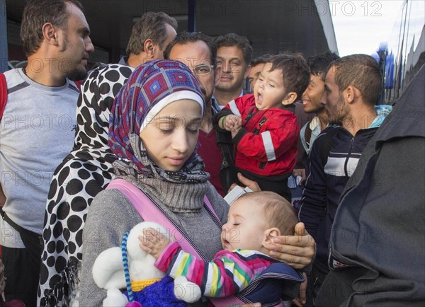 Syrian refugees have arrived at Schoenefeld station on a special train. They are then taken by bus