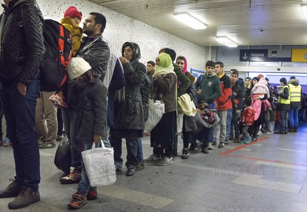 Refugees have arrived at Schoenefeld station on an IC train. They are then taken by bus to