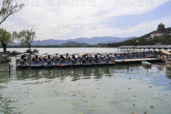 New Summer Palace, Beijing, China, Asia, Tourist boats on a lake with green water in front of a