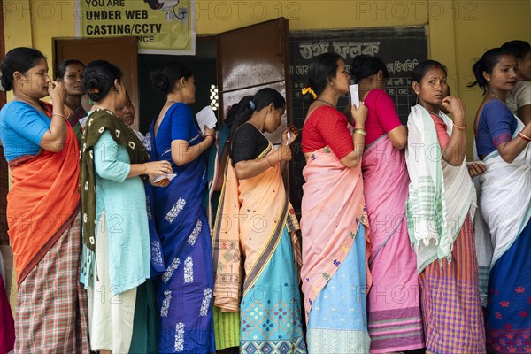 BOKAKHAT, INDIA, APRIL 19: Voters wait in line at a polling station to cast their votes during the