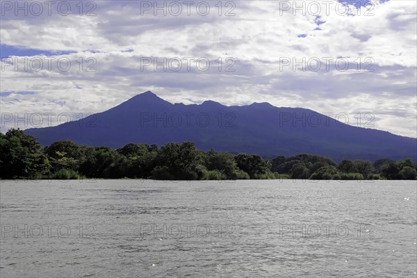 Granada, Nicaragua, Wide view of Lake Nicaragua in front of a mountain, spanned by a blue sky with