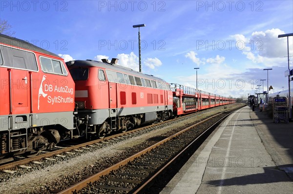 Red DB AutoZug Sylt Shuttle standing on tracks in sunny weather, Sylt, North Frisian Island,