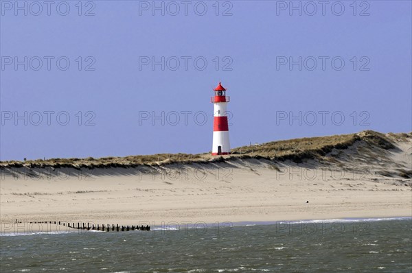 Lighthouse with blue sky at the elbow, North Sea, North Sea island, island, Sylt, red and white