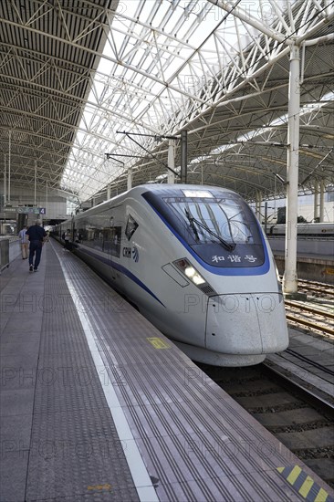 Fast trains, CRH on the platform, Hongqiao railway station, Shanghai, China, Asia. Travellers walk