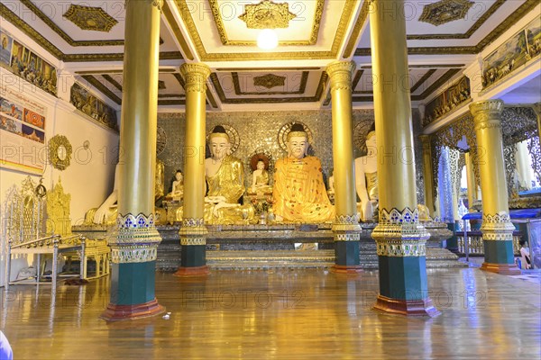 Shwedagon Pagoda, Yangon, Myanmar, Asia, Golden Buddha statues in a richly decorated interior of a