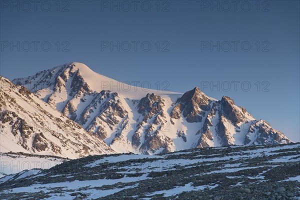 Sunrise at the snowy Cold Peak, Mongolian Chueiten, 3373m, Tavan Bogd National Park, Mongolian
