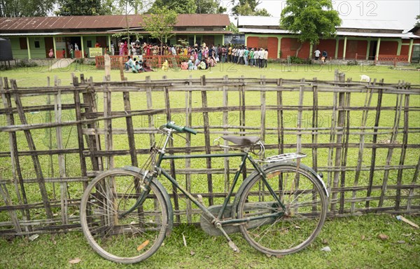 BOKAKHAT, INDIA, APRIL 19: Voters wait in line at a polling station to cast their votes during the