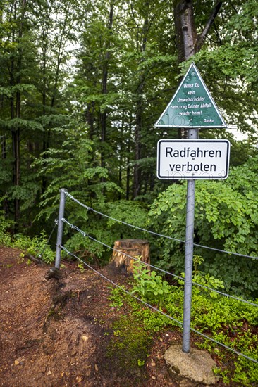 Keeping the environment clean, message to polluters and cyclists on a sign at the upper entrance to