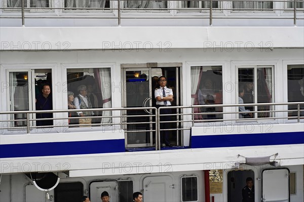 Chongqing, Chongqing Province, China, people looking through ship windows, some socialising, others