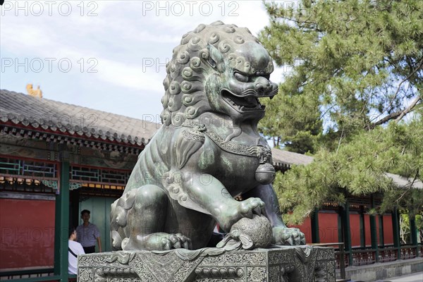 New Summer Palace, Beijing, China, Asia, Statue of a Chinese stone lion in front of traditional