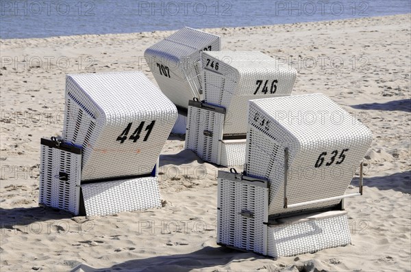 On the beach, Hoernum, Sylt, North Frisian Island, White beach chairs with numbers on a sandy beach