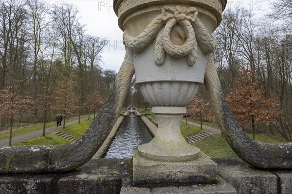 View from a stone bridge with an ornamental vase onto a canal in the castle park, Ludwigslust,