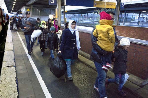 Refugees have arrived at Schoenefeld station on an IC train. They are then taken by bus to