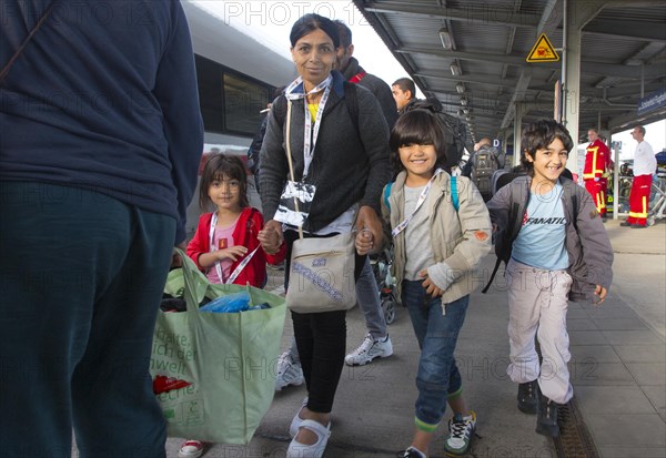 Syrian refugees have arrived at Schoenefeld station on a special train. They are then taken by bus