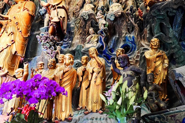 Jade Buddha Temple, Shanghai, Detailed colourful relief of Asian sculptures with dynamic