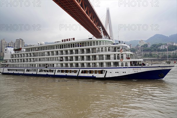 Chongqing, Chongqing Province, China, Side view of a large white cruise ship sailing on a river,
