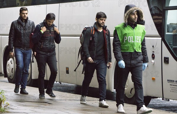 Refugees have arrived at Schoenefeld station on an IC train. They are then taken by bus to