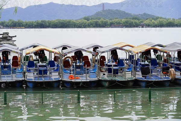 New Summer Palace, Beijing, China, Asia, Several boats on a calm lake in front of a mountain