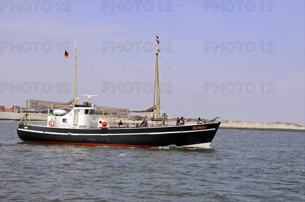 Sylt, North Frisian Island, Schleswig Holstein, A small ship with German flags sails on the sea,