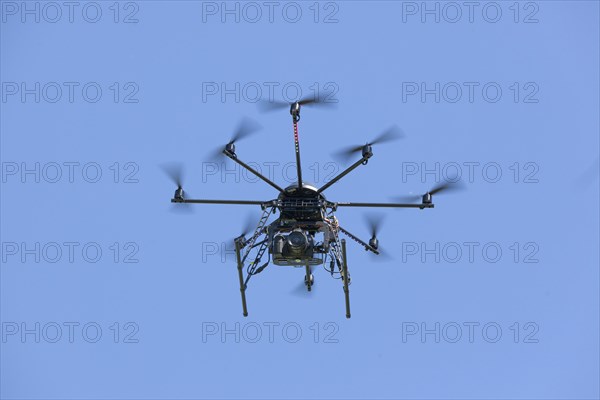 Drone with eight propellers, octocopter, in flight with camera for film and photo shoots, 07.06