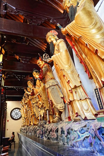 Jade Buddha Temple, Shanghai, group of carved Buddha statues and wall relief in wood-panelled