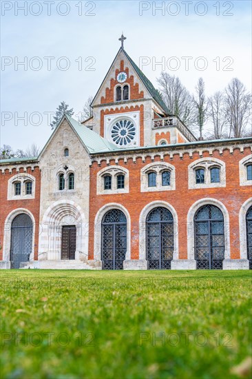 Historic church with Gothic style and brick facade under a cloudy sky, Bad Reichenhall, Alte