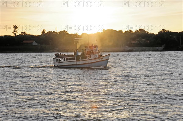 Lake Nicaragua, Ometepe Island in the background, Small boat on a lake at sunset, with light