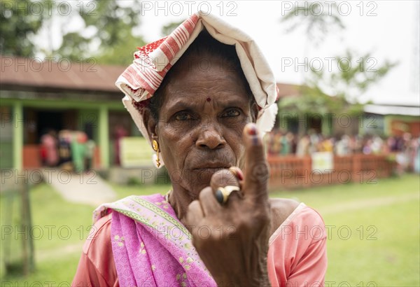 BOKAKHAT, INDIA, APRIL 19: A women show her marked finger after casting vote during the first phase