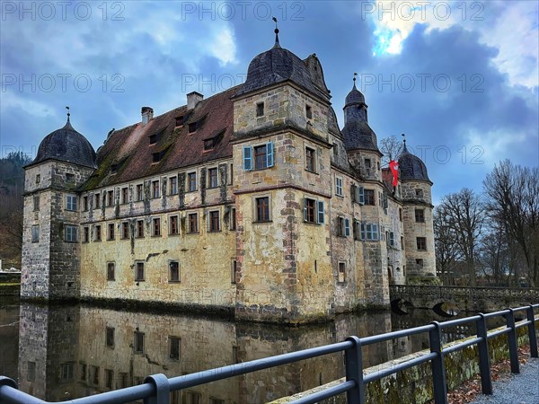 Mitwitz moated castle under a cloudy sky. Mitwitz, Kronach, Upper Franconia, Bavaria, Germany,