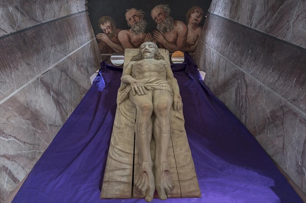 Reclining figure of Christ in the Holy Sepulchre, behind a motif of three men in purgatory, St