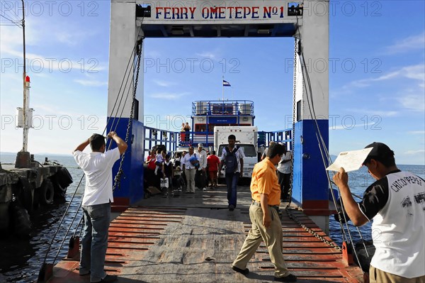 Lake Nicaragua, people boarding a ferry via a jetty, on the shore with clear sky, Nicaragua,