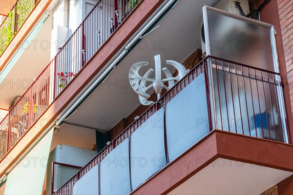 Balcony power plant and mini wind turbine on a balcony of a high-rise building in Barcelona, Spain,