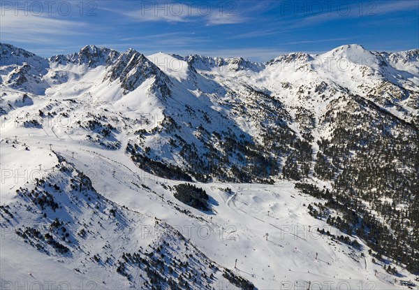 View of several mountain peaks and snowy landscapes with some trees visible, Grau Roig, Encamp,