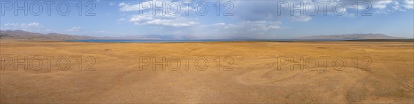 Aerial view, Vast empty landscape at the mountain lake Song Kul in autumn, Moldo Too Mountains,
