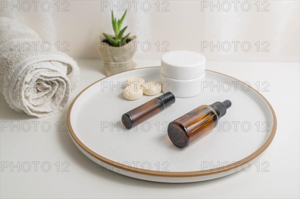 Cosmetic packaging. Set of different cosmetics on plate with decoration. Skin care concept