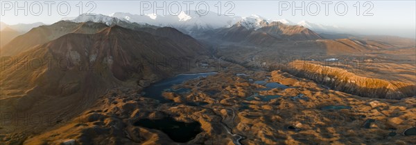 Aerial view, high mountain landscape with glacial moraines and mountain lakes, behind Pik Lenin,